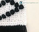 close up of black bobble stitches on white background