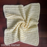 chunky crochet baby blanket spread on the floor