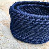 a smaller crochet basket nested inside a larger basket
