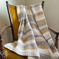 textured crochet blanket draped on a chair
