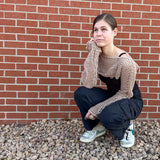 teen wearing a crochet mesh crop top with long sleeves