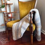 suzette stitch crochet blanket draped on a chair