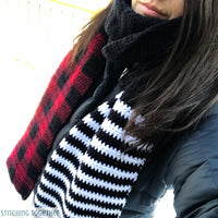 scarf with buffalo plaid on one end and black and white stripes on the other end