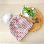 pink crochet beanie hat flat lay
