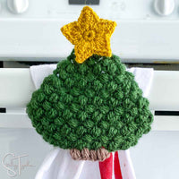close up of crochet christmas tree with star and little trunk