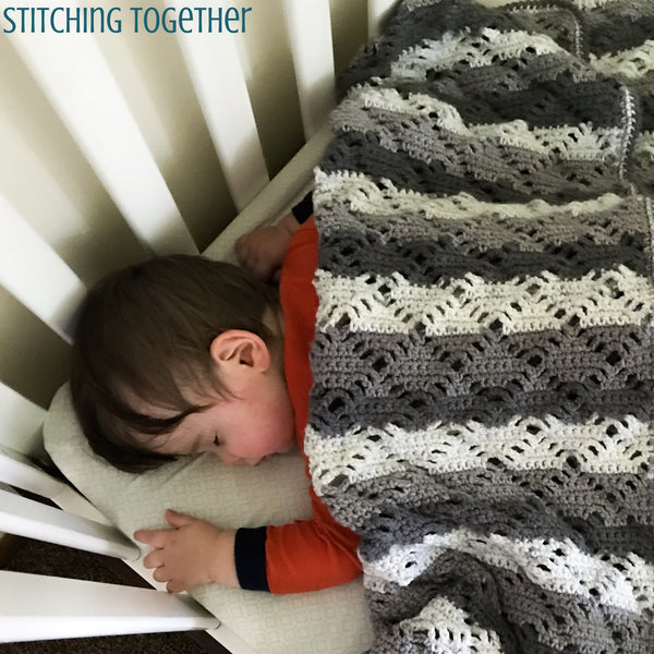 baby asleep under crochet blanket