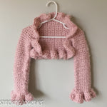 pink crochet shrug hanging