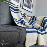 striped crochet afghan draped on a couch