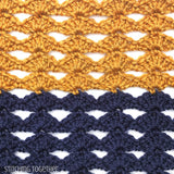 close up of crochet diamond shell stitches in blue and gold colors