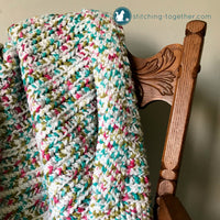 close up of colorful crochet baby blanket