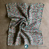 crochet baby blanket styled on the floor