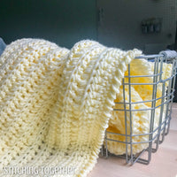 bulky crochet baby blanket in a basket