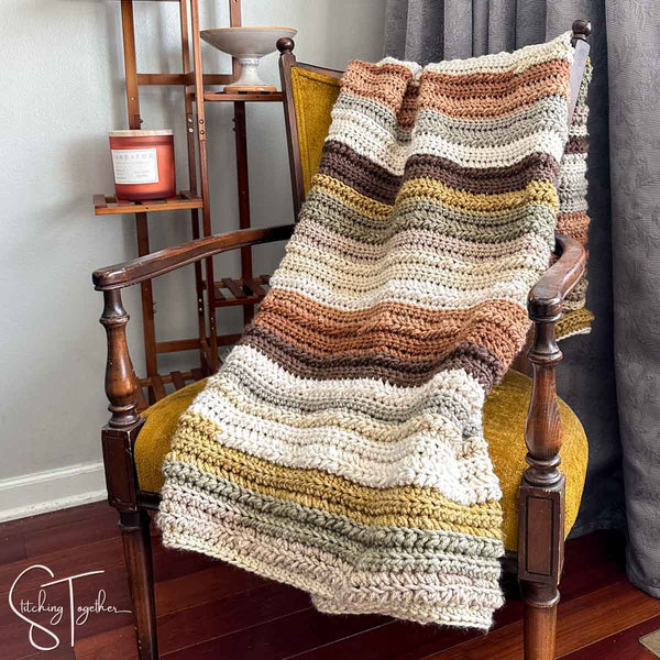 striped chunk crochet blanket draped on a chair