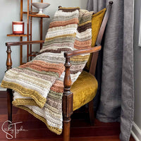 striped chunk crochet blanket draped on a chair