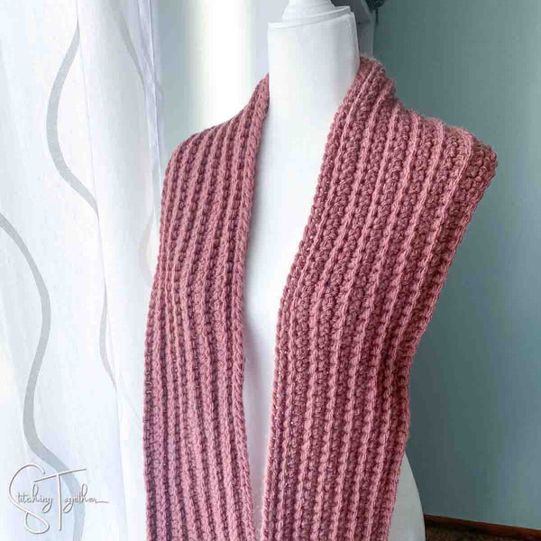 bulky yarn crochet scarf draped on a mannequin