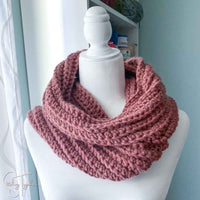 bulky crochet scarf wrapped on a mannequin