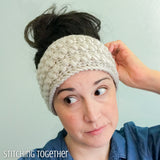 lady wearing a neutral colored crochet headband