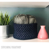 blue crochet basket sitting on shelf