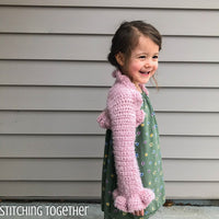 little girl wearing pink crochet bolero with ruffles