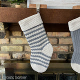 striped crochet stocking hanging on a mantle