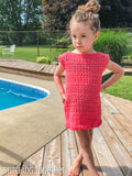 girl wearing a crochet summerdress while standing by a pool