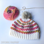 colorful women's crochet hat with a ball colorful yarn