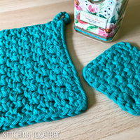 2 potholders crocheted in teal yarn
