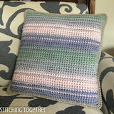 crochet pillow with differently colored stripes