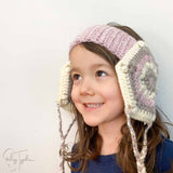 child wearing crochet head warmer