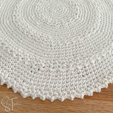 close up of the stitches of a round crochet placemat