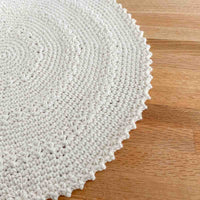 close up of the stitches of a crochet round placemat