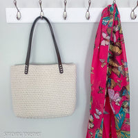 crochet bag hanging next to a bright scarf
