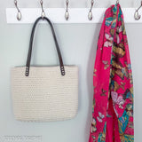crochet bag hanging next to a bright scarf