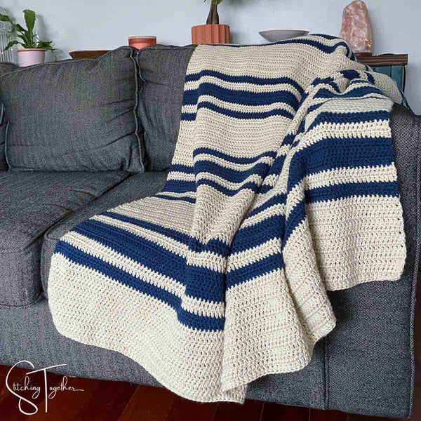 striped crochet blanket draped on a couch