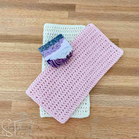 folded double crochet dishcloths with a bar of soap