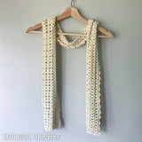 ivory thin scarf draped on a hanger