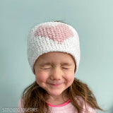 girl wearing crochet heart headband