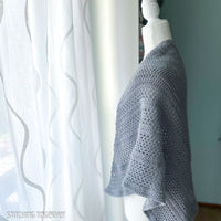 gray crochet shawl on mannequin 