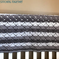 unisex crochet baby blanket on crib