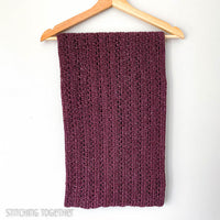 folded crochet  infinity scarf on a hanger