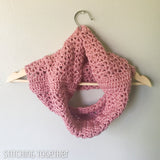 pink crochet cowl on a hanger