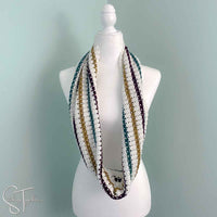 striped crochet infinity scarf draped around the neck of a mannequin
