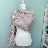 Crochet shawl with open stitch work wrapped on a mannequin 