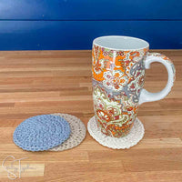round crochet coaters with a colorful coffee mug