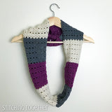 striped crochet infinity scarf on a hanger