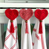 heart crochet towel toppers holding red and white colored towels